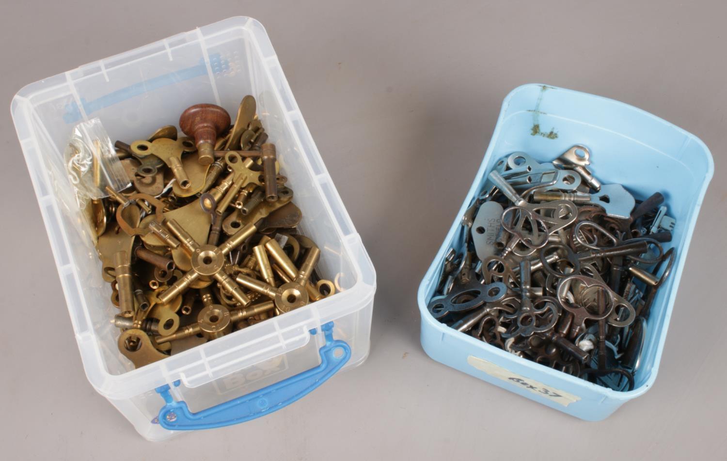 Two boxes of various clock keys.