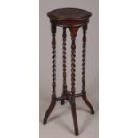 A carved mahogany barley twist jardinière/plant stand.