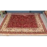 A full pile red ground Kashmir carpet. With the Tree of Life design. (320cm x 240cm).