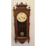 A cased mahogany cased wall clock. By Ansonia clock company ltd.