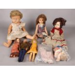 A selection of six vinyl dolls - together with two bags of doll parts and clothes. Tallest doll :