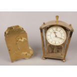 A Koma brass and glass torsion clock along with a clock movement.