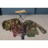 A box of assorted items. Includes camouflage jacket, similar sheet, travel stool, ties and