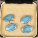 A pair of silver cufflinks with blue enamel decoration.