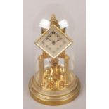 A German brass torsion clock under glass dome and diamond shape dial.