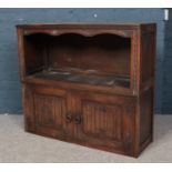 Two carved and panelled oak units. Including one cupboard example with linen fold decoration.