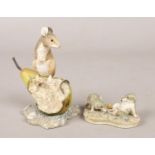 Two Border Fine Arts figures. One by Ray Ayres, mouse on a pear, and another by Peter Miles.