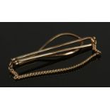 A 9ct gold tie clip with safety chain. 4.83g.