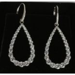 A pair of silver cubic zirconia hoop earrings. Marked DQCZ.