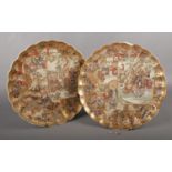 A pair of Japanese Satsuma plates, decorated with Samurai. (Diameter 31.5cm). Chips and repair to