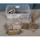 A box of metalwares. Including small mirror decorated with a unicorn, flatware, picture frame, brass