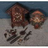 Two carved cuckoo clocks. In need of restoration.