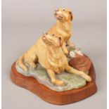 A limited edition Border Fine Arts model of two hunting dogs. On wooden base. Signed Hayton '75.