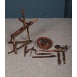 A wooden turned spinning wheel, currently dismantled.
