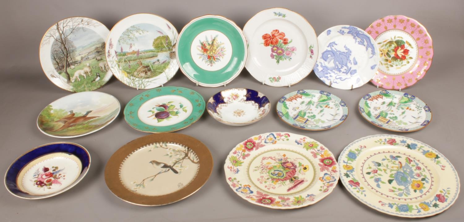 A quantity of mostly hand painted display plates.