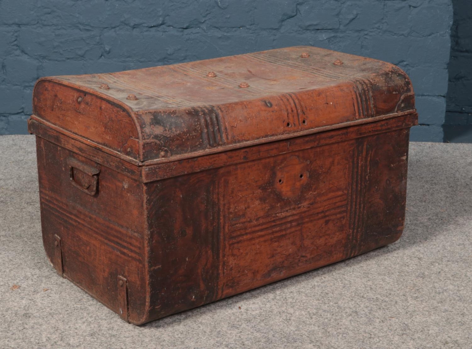 A vintage twin handle tin trunk. Missing lock.