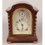 A Winterhalder & Hofmeier oak cased 8 day mantel clock with barley twist columns. Movement marked