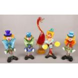 Four murano glass clowns along with a similar duck example.
