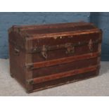 A dome top wood and metal bound trunk.