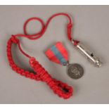 A George VI Imperial Service medal and an ARP whistle. Whistle by J Hudson & Co. Medal presented