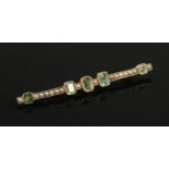 A gold emerald and seed pearl bar brooch. Unmarked. (4.6g).