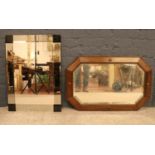 Two wall mirrors- comprising of an early 20th century Oak framed bevelled edged mirror together with