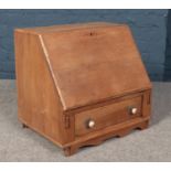 An oak table top bureau. (Height 50cm Width 53 Depth 41cm).