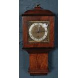 A small Bravington's mahogany cased wall clock with key. (40cm)