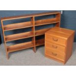 A teak G Plan EGomme Garrick bedside chest of three drawers along with an oak wall mounting