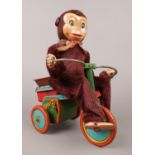 A Japanese made monkey on a tin plate tricycle. H:22cm, W: 10cm. Condition fair. Will need some