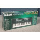 A boxed Yamaha Portatone PSR-200 keyboard.