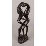 A ebonised wooden figure group of two lovers. (30cm tall)