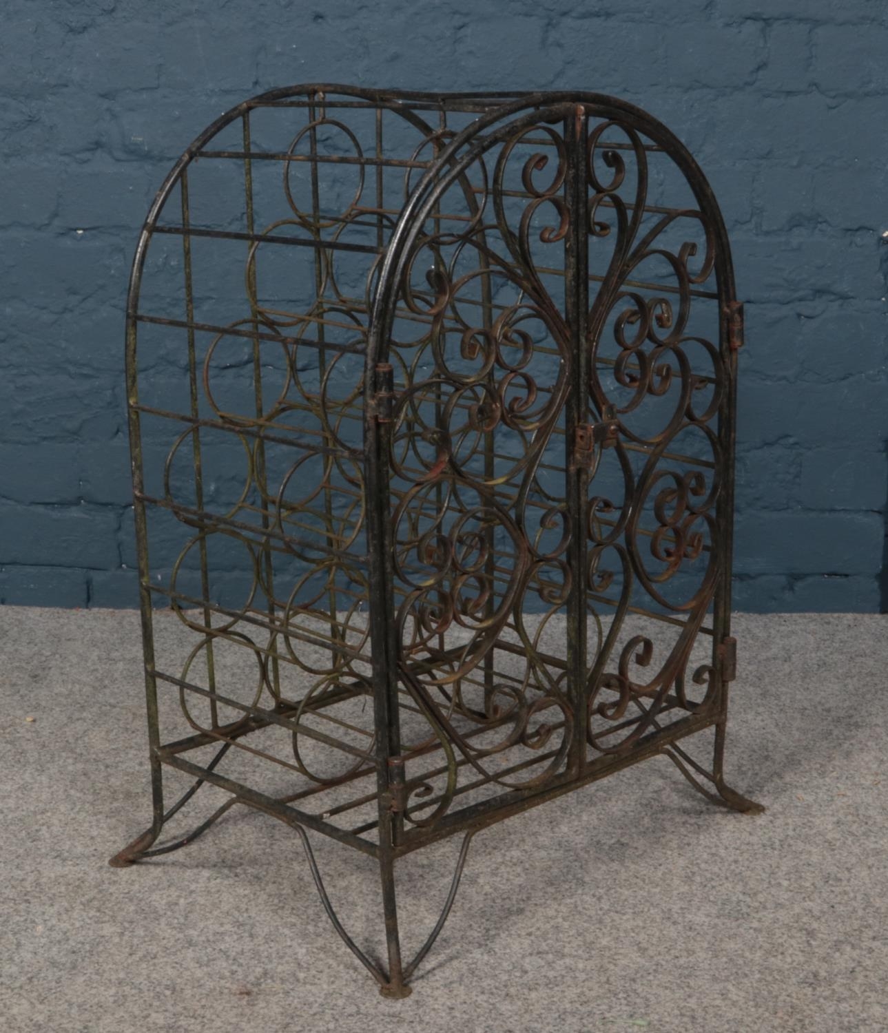 A wrought iron wine rack with gated front.
