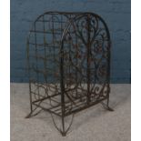 A wrought iron wine rack with gated front.