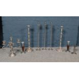 A selection of assorted sized metal candlesticks. Comprising of a pair of chrome & oak