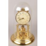 A Hess brass torsion clock under dome.