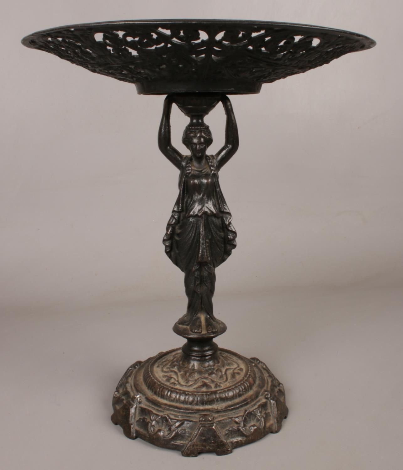 A cast iron 'Lady Tessa' centrepiece. Decorated in a classical style. H: 34cm, W: 29cm. Condition
