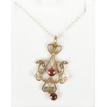 A 9ct gold garnet and seed pearl pendant on 9ct gold chain.