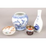 A group of oriental ceramics. Includes blue and white vase, miniature bowl on wooden stand etc.