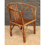 A child's Bamboo & hardwood chair with leather patterned seat. H: 48cm, W: 39cm, D: 26cm.