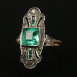 A 9ct gold and silver dress ring with green and white paste stones. Size J, 3.03g.