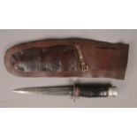 A vintage dagger with leather sheath. Handle in need of repair.
