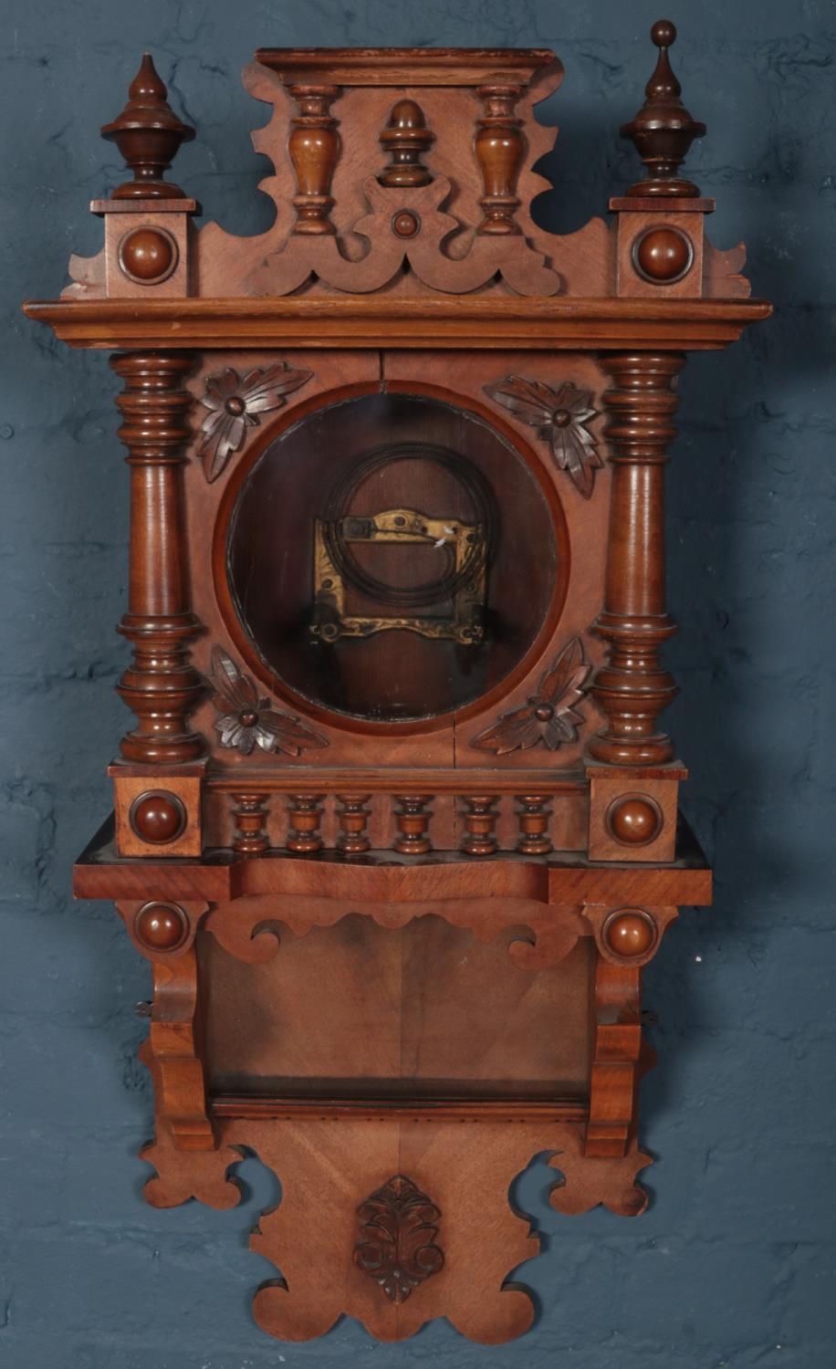 A carved mahogany wall clock case. Parts of finial missing.426