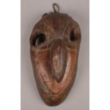 An African tribal hardwood grotesque mask.