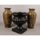 A pottery pedestal font/planter, along with a pair of pottery vases with gilt decoration.