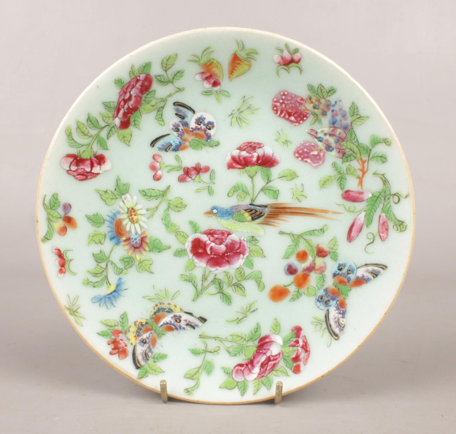 A 19th century Chinese celadon plate. Decorated with bird, butterflies and flowers. (18.5cm)