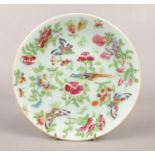 A 19th century Chinese celadon plate. Decorated with bird, butterflies and flowers. (18.5cm)