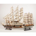 Three wooden model sail boats. Cutty Sark, Bounty and one other.