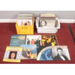Two boxes of vinyl LP records. Including Pretenders, Santana, Steve Winwood, Genesis, Moody Blues,