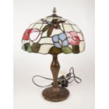 A Tiffany style desk lamp, with a dragonfly and floral design and metal base. H: 46cm. Condition